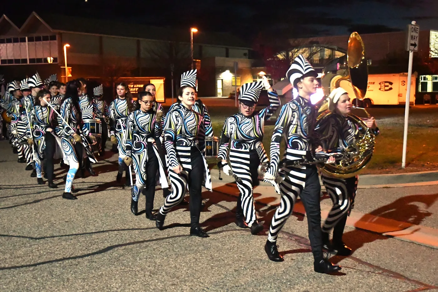 South Lyon marching band students moving together near the stadium after dark in 2025