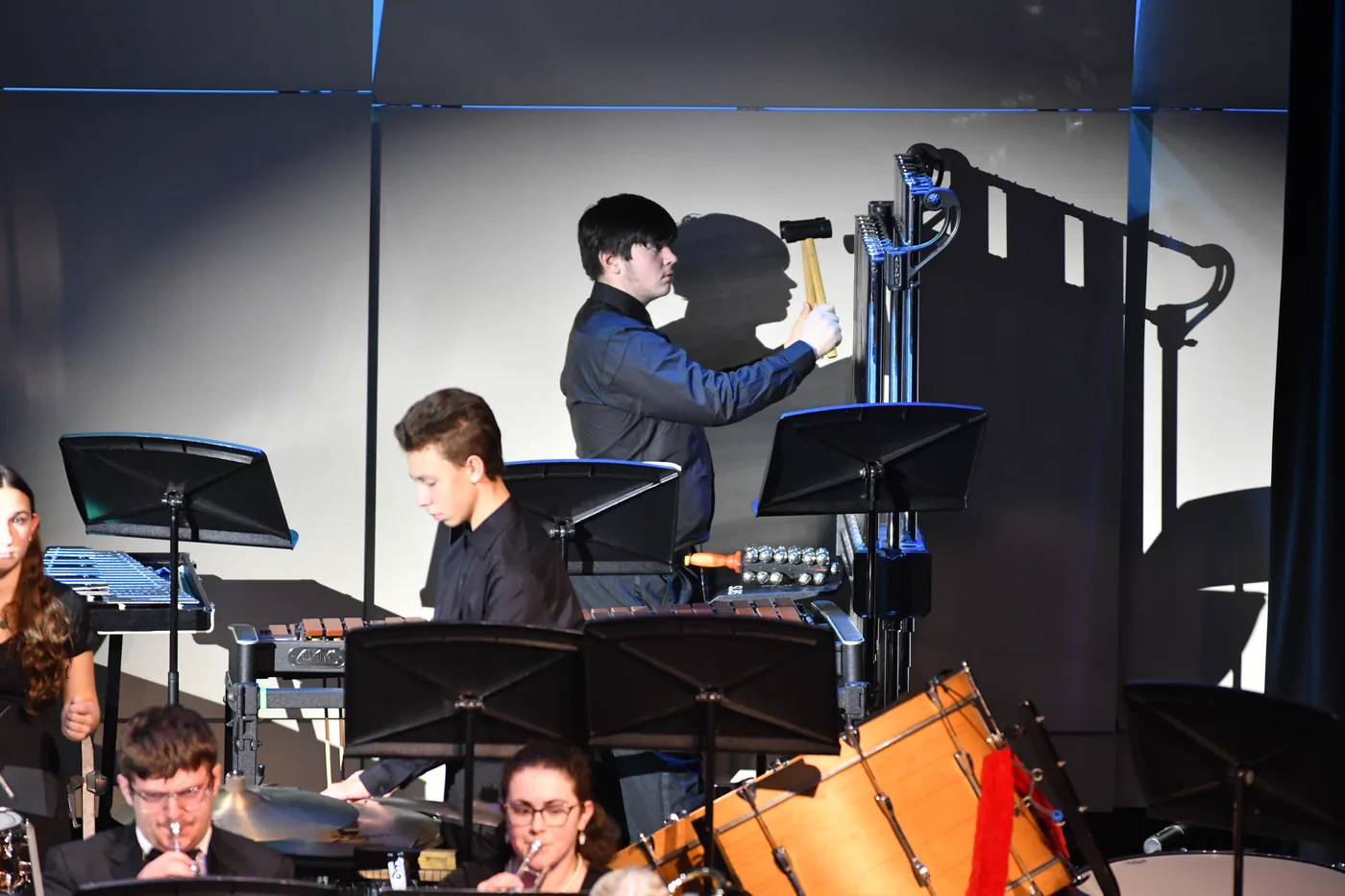 South Lyon student percussionists performing alongside the concert band at the December 2025 concert