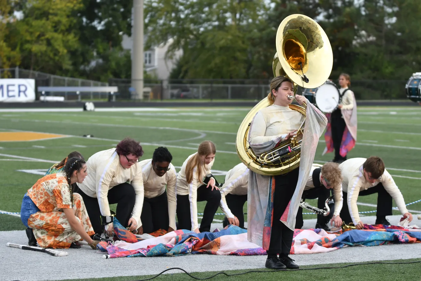 South Lyon marching band members supporting a performance