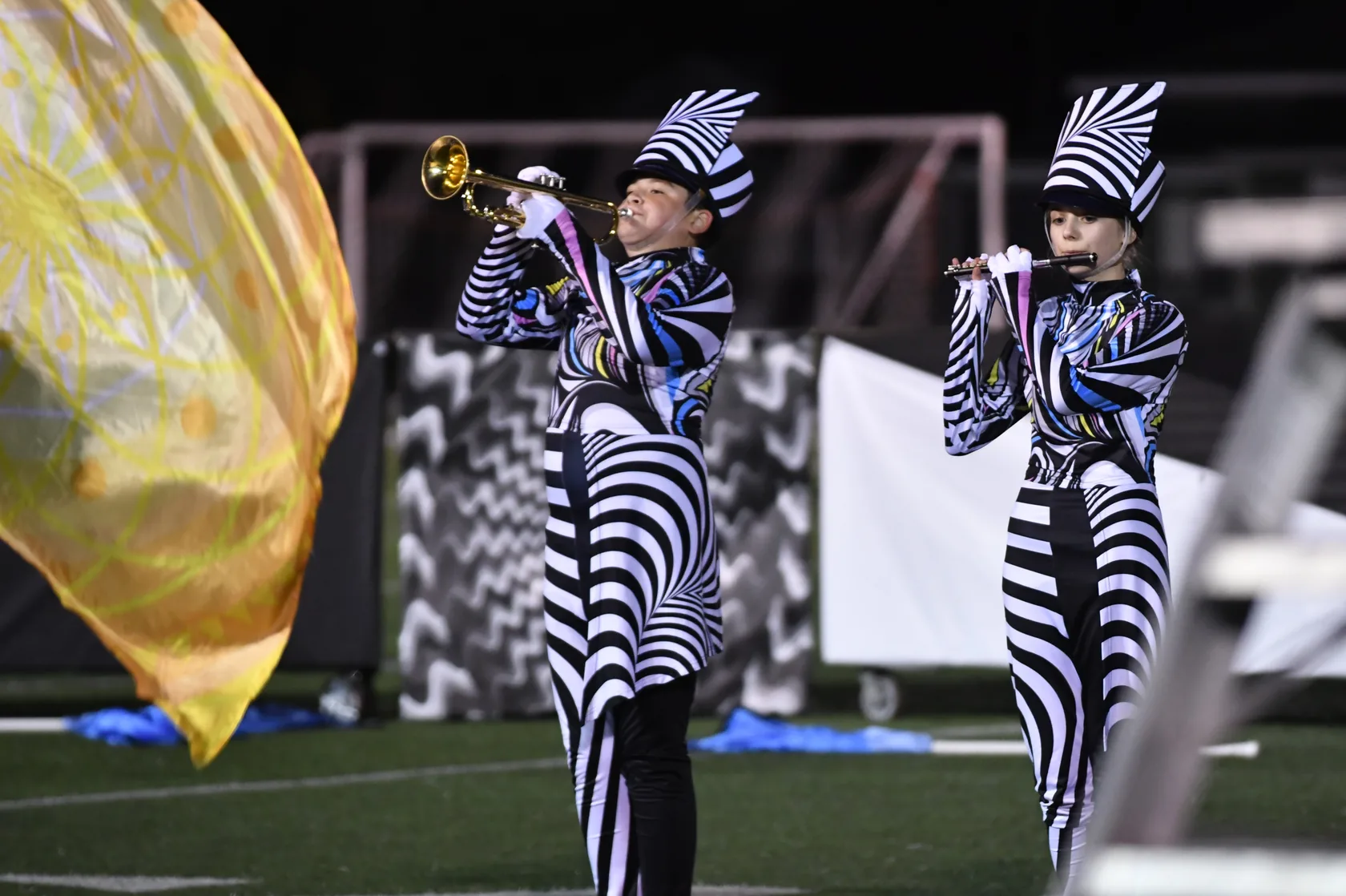 South Lyon brass musicians performing on the football field in 2025