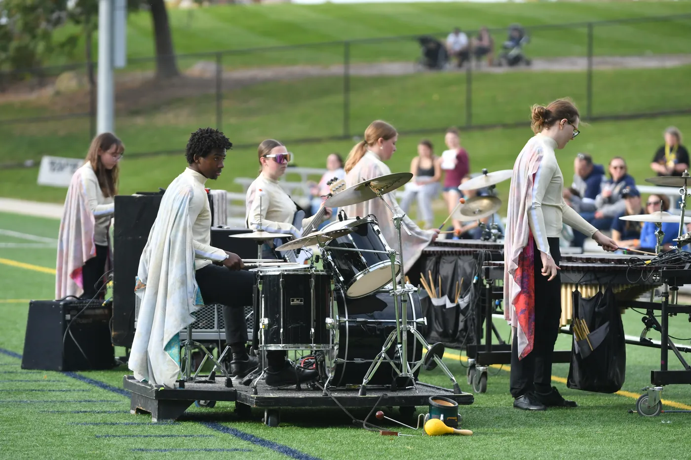 South Lyon percussion musicians rehearsing at a football field in 2026