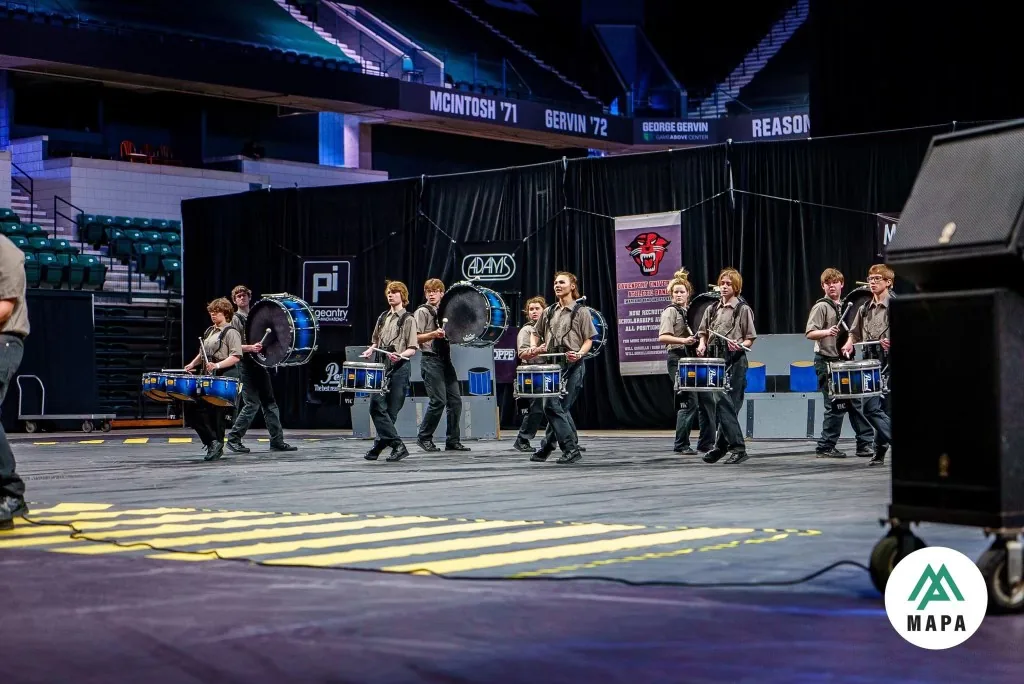South Lyon Percussion members performing together at an indoor event in 2023